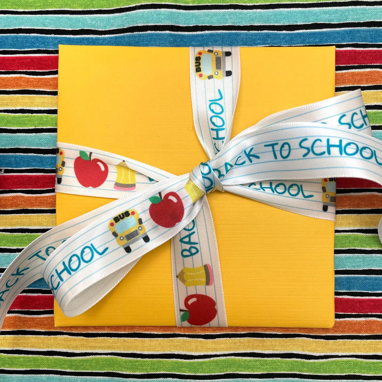 Back to School Ribbon with notebook lines, apples, busses and pencils printed on 7/8"white satin