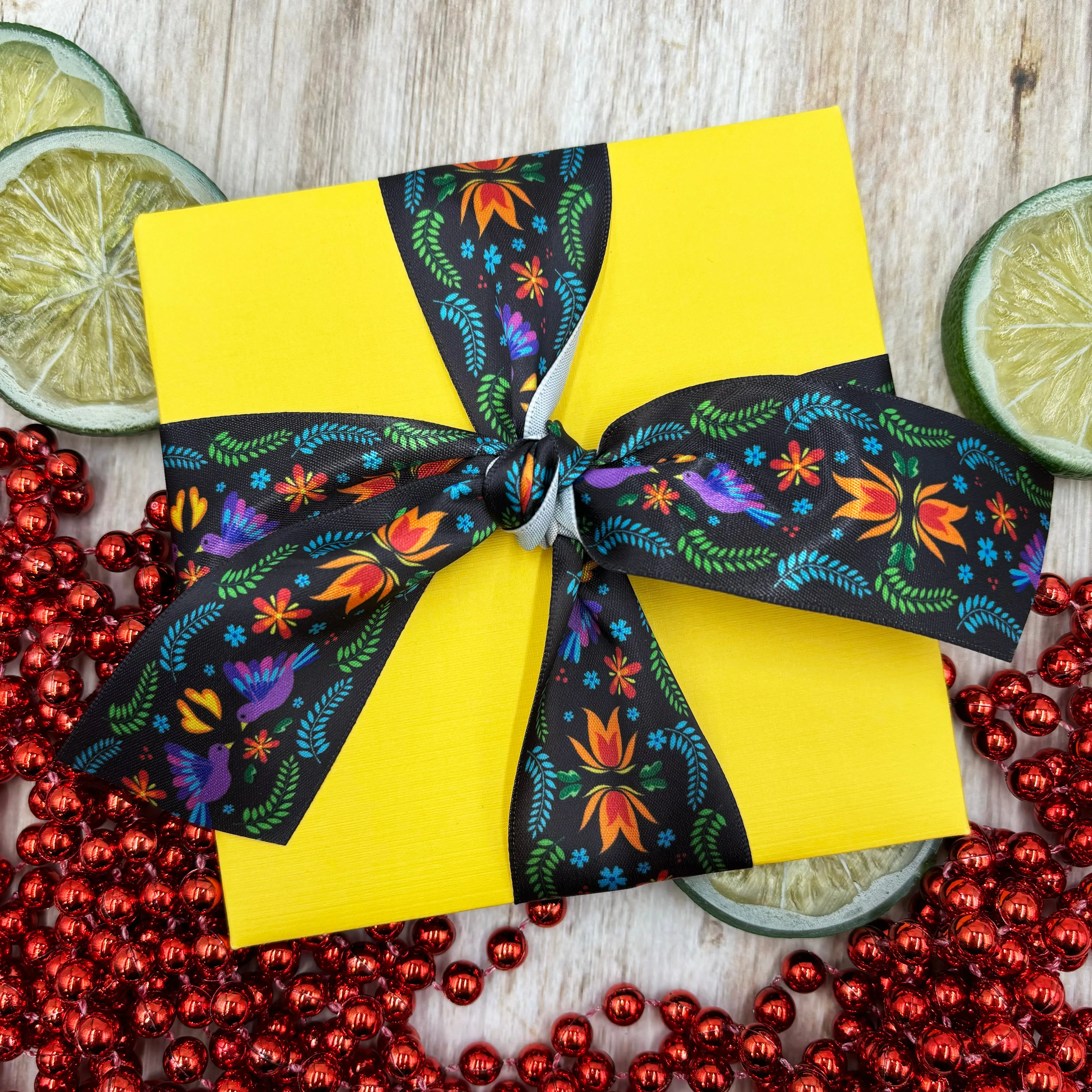 Mexican Floral Ribbon flowers of orange and turquoise with purple birds and green flora on a black background printed on 1.5" satin and grosgrain